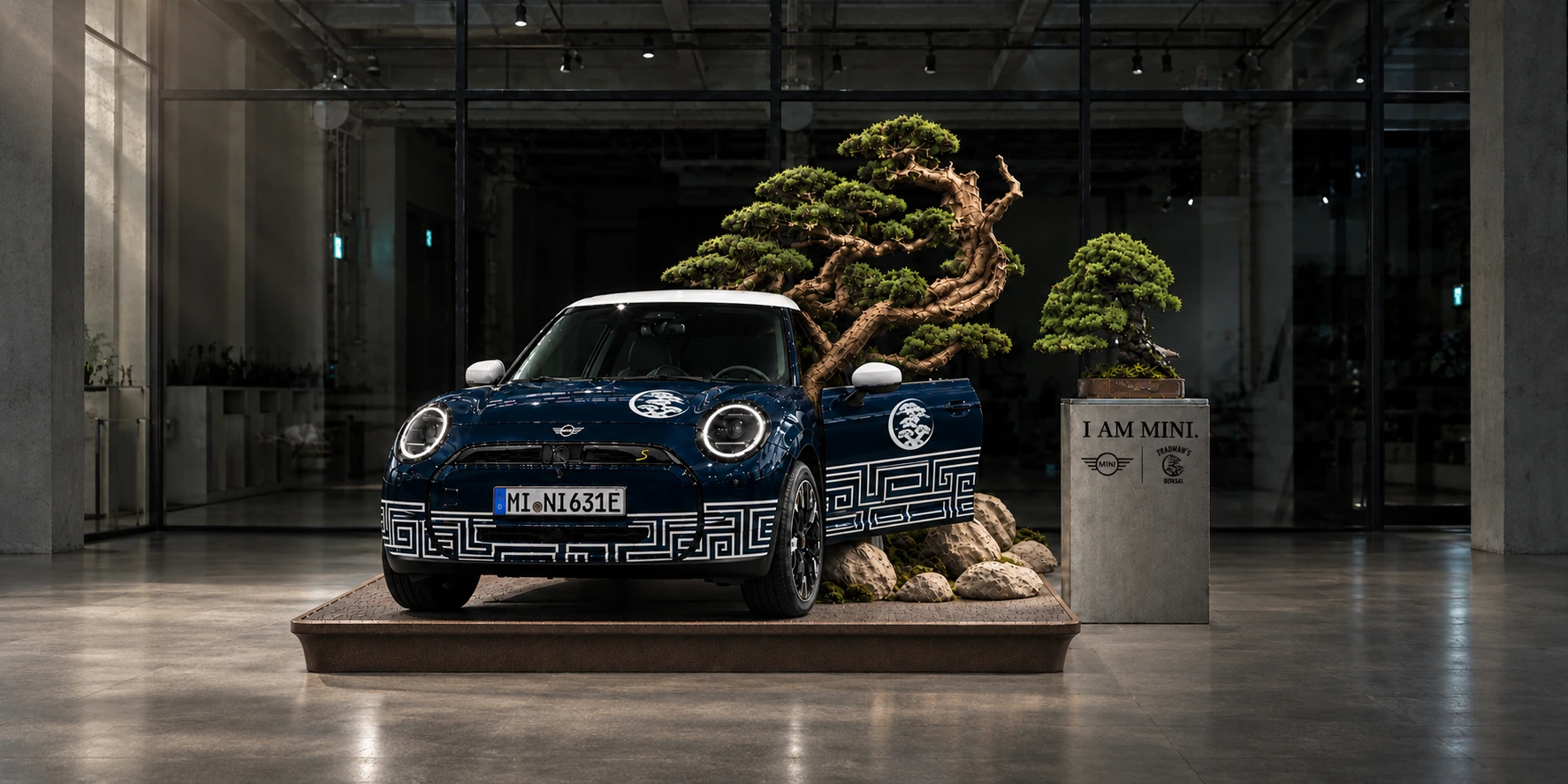 The blue MINI × TRADMAN’S Signature Cooper and sculptural bonsai installation in a softly lit gallery