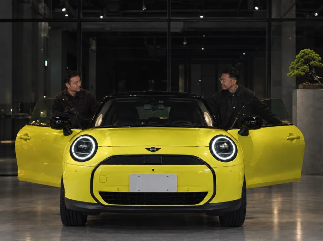 Teppei Kojima and a MINI Japan host beside a yellow MINI Cooper